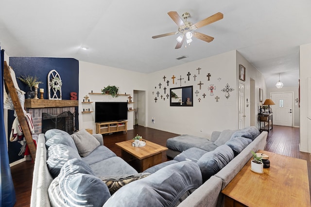 8121 Kathleen Dr, Fort Worth, TX 76137 - living area featuring a brick fireplace, dark wood-style flooring, ceiling fan, and visible vents