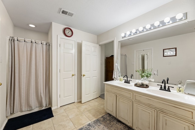 8121 Kathleen Dr, Fort Worth, TX 76137 - full bathroom with tile patterned floors, double vanity, visible vents, and a sink