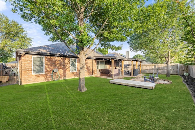 8121 Kathleen Dr, Fort Worth, TX 76137 - back of property with a yard, a chimney, brick siding, a jacuzzi, and a fenced backyard
