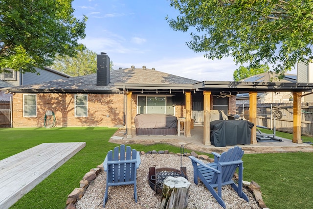 8121 Kathleen Dr, Fort Worth, TX 76137 - back of house featuring a hot tub, a deck, a yard, a fenced backyard, and a chimney