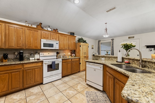 8121 Kathleen Dr, Fort Worth, TX 76137 - kitchen featuring decorative backsplash, visible vents, brown cabinets, a sink, and white appliances