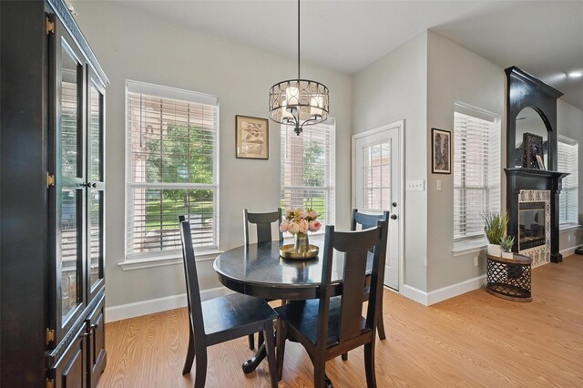 dining area with healthy amount of natural light, baseboards, and light wood-style flooring