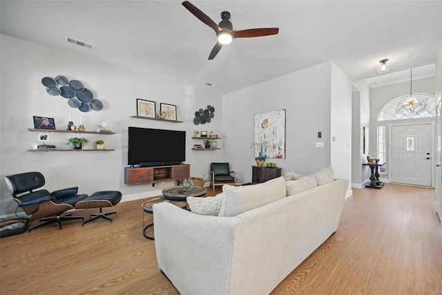 living area featuring ceiling fan, wood finished floors, and baseboards