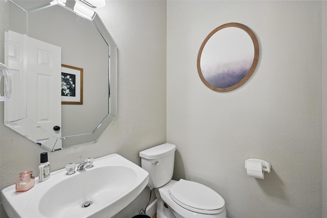 half bath with a sink and toilet
