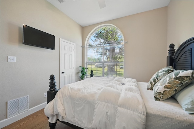 bedroom with baseboards, wood finished floors, and ceiling fan