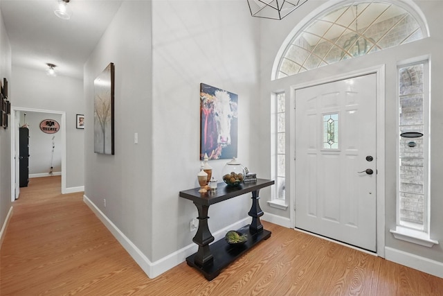 entrance foyer featuring light wood-style flooring and baseboards