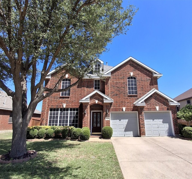 527 E Sandra Ln, Grand Prairie, TX 75052 - traditional-style house with a garage, a front yard, driveway, and brick siding