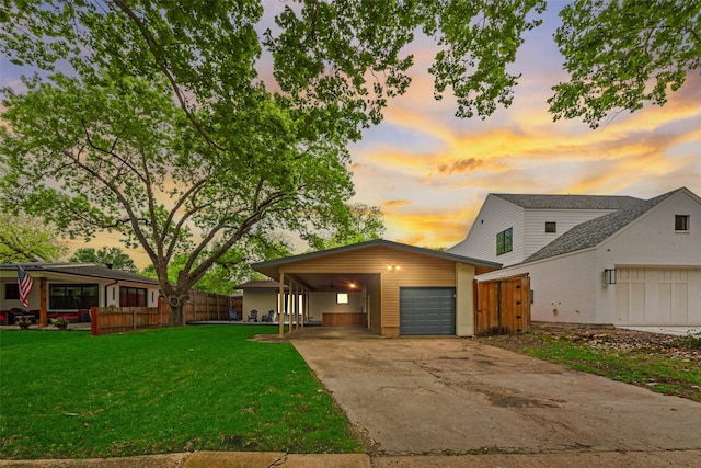 view of front of house featuring a garage, a carport, fence, a front lawn, and concrete driveway