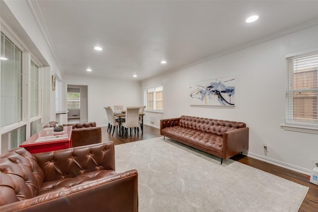 living room with dark wood-style flooring, baseboards, recessed lighting, and ornamental molding