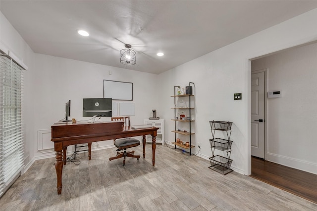 office space featuring baseboards, plenty of natural light, recessed lighting, and wood finished floors