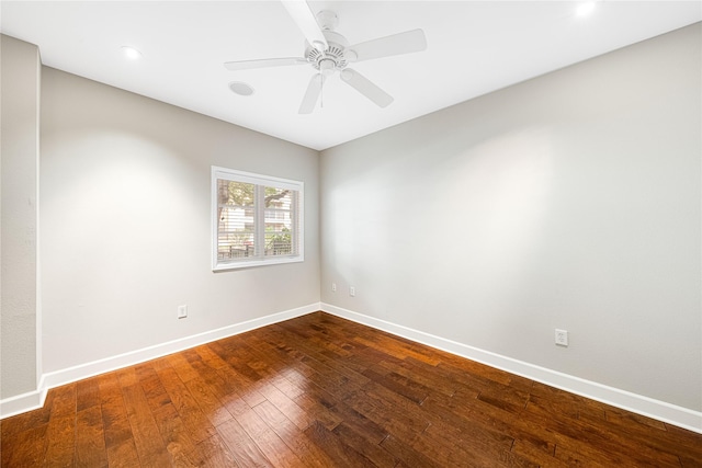 spare room featuring recessed lighting, baseboards, a ceiling fan, and dark wood finished floors