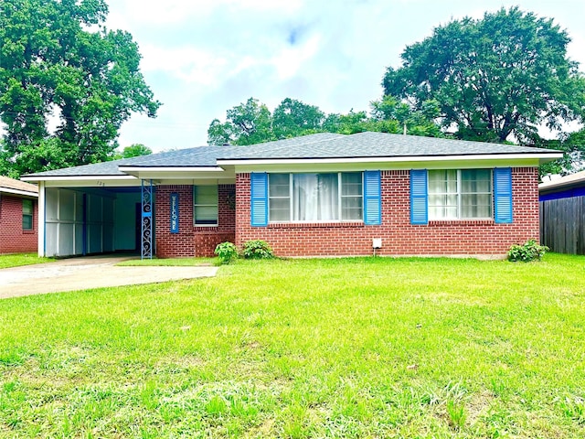 ranch-style house featuring an attached carport, brick siding, driveway, and a front lawn