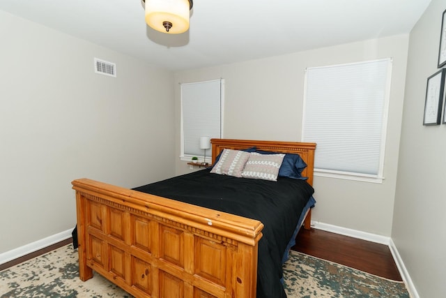 bedroom featuring wood finished floors and baseboards