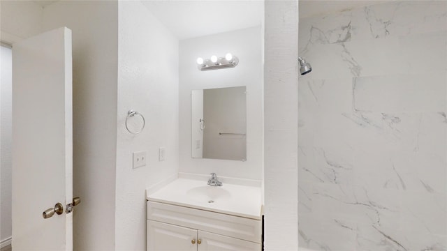 bathroom with vanity and a shower
