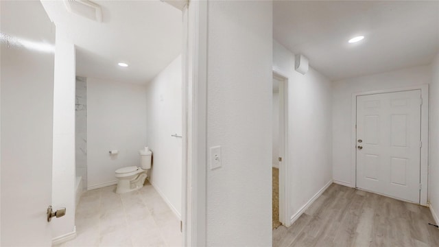 hallway featuring baseboards, recessed lighting, and visible vents