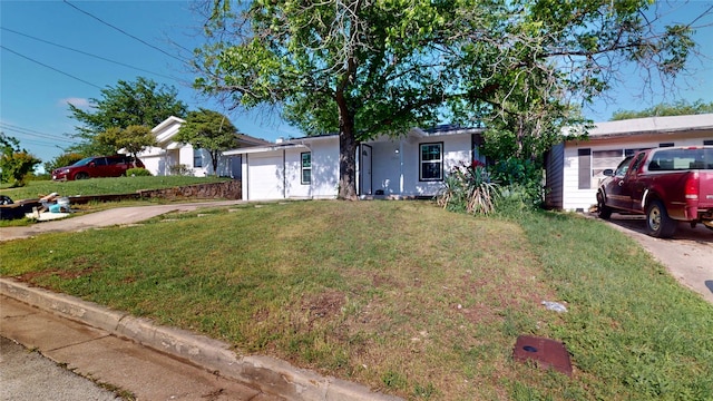 ranch-style home featuring an attached garage and a front lawn