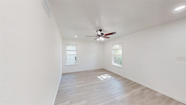 unfurnished room with visible vents, baseboards, recessed lighting, a ceiling fan, and light wood-style flooring