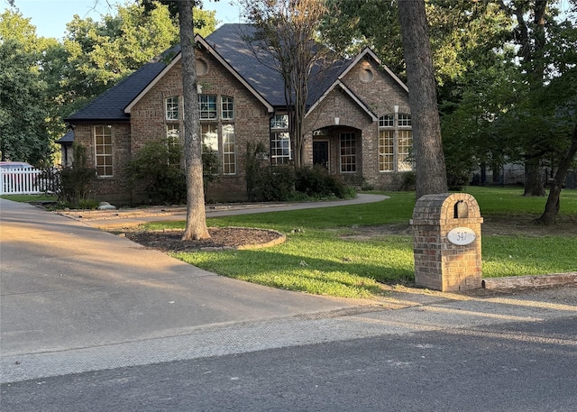 347 Saint Andrews Dr, Mabank, TX 75156 - view of front of house featuring brick siding, a front yard, and a shingled roof