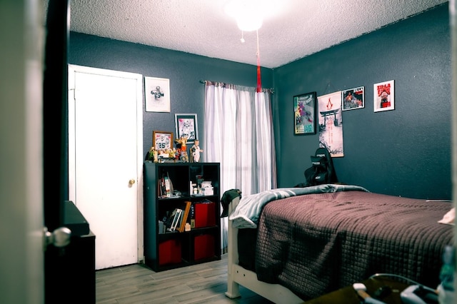 1213 Dennis Dr, Saginaw, TX 76179 - bedroom with a textured ceiling, a textured wall, and wood finished floors
