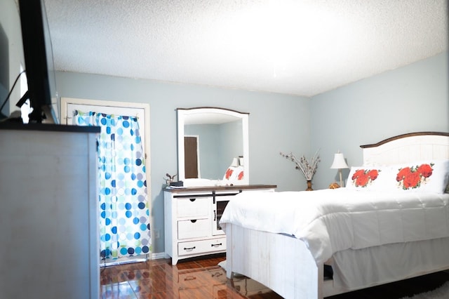 1213 Dennis Dr, Saginaw, TX 76179 - bedroom featuring a textured ceiling and wood finished floors