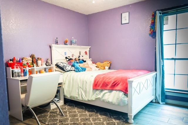 1213 Dennis Dr, Saginaw, TX 76179 - bedroom with a textured ceiling and wood finished floors