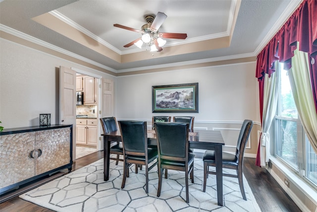 2516 Nighthawk Dr, Plano, TX 75025 - dining room with crown molding, ceiling fan, dark wood-style floors, and a raised ceiling