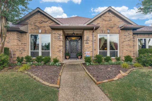 2516 Nighthawk Dr, Plano, TX 75025 - view of front facade featuring brick siding, roof with shingles, and a front yard