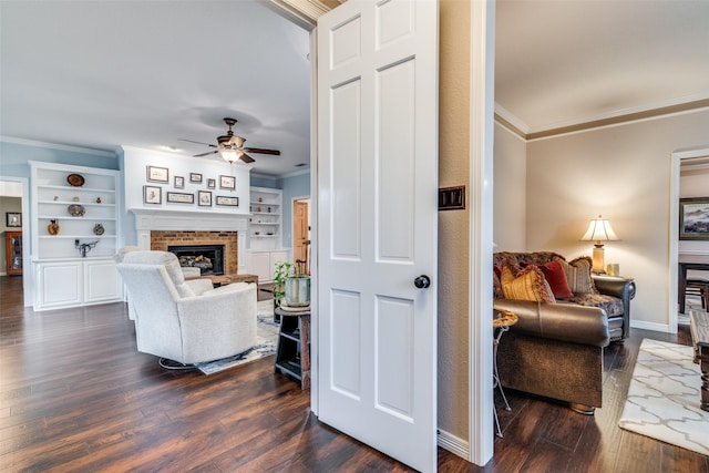 2516 Nighthawk Dr, Plano, TX 75025 - living area featuring dark wood-type flooring, ornamental molding, a brick fireplace, and ceiling fan