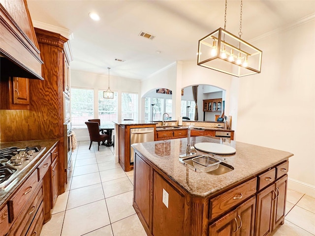 kitchen featuring arched walkways, a sink, brown cabinets, custom exhaust hood, and ornamental molding