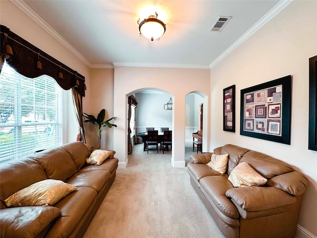 living area with arched walkways, crown molding, light colored carpet, and baseboards