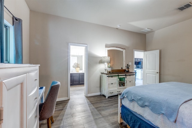 2868 Pacifico Way, Fort Worth, TX 76111 - bedroom featuring wood finished floors, baseboards, ensuite bathroom, and an office area