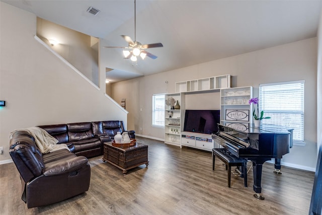 2868 Pacifico Way, Fort Worth, TX 76111 - living room with baseboards, ceiling fan, wood finished floors, stairs, and high vaulted ceiling
