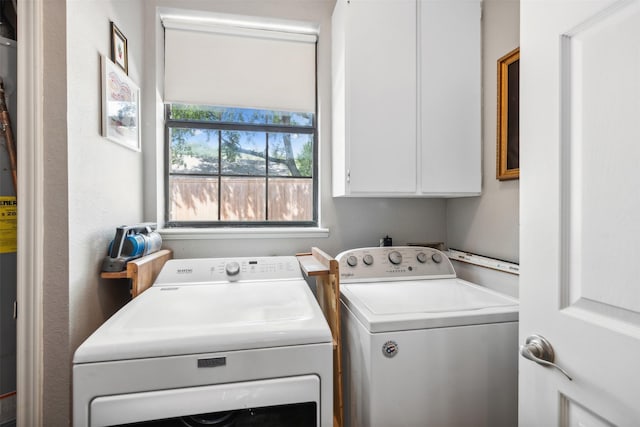 washroom featuring washer and clothes dryer and cabinet space