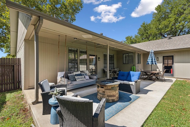 view of patio / terrace with fence and an outdoor living space with a fire pit