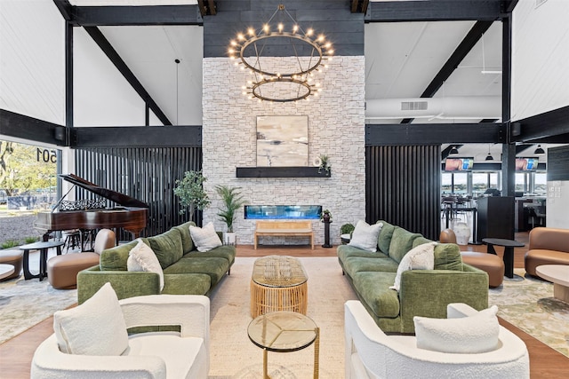 living area with visible vents, plenty of natural light, a towering ceiling, and beamed ceiling