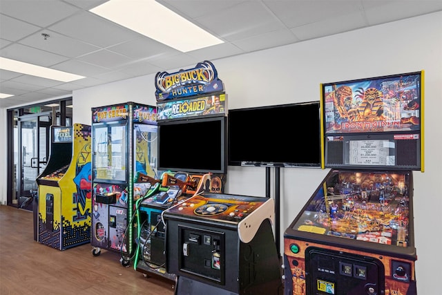 game room with a drop ceiling and wood finished floors