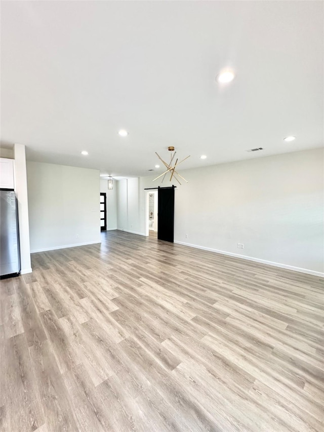 303 Third, Lindsay, TX 76250 - unfurnished living room with recessed lighting, light wood-style flooring, baseboards, and visible vents