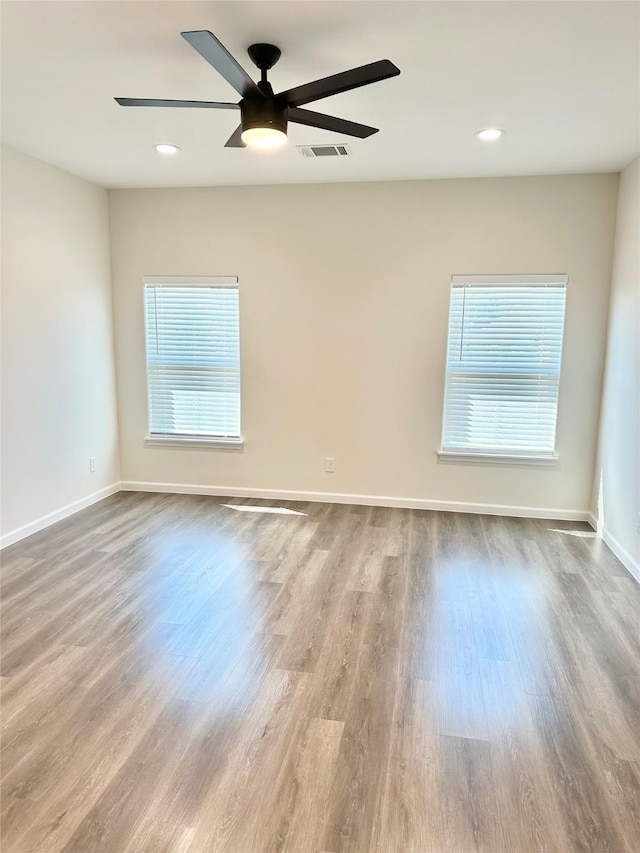 303 Third, Lindsay, TX 76250 - unfurnished room with a healthy amount of sunlight, baseboards, wood finished floors, and visible vents