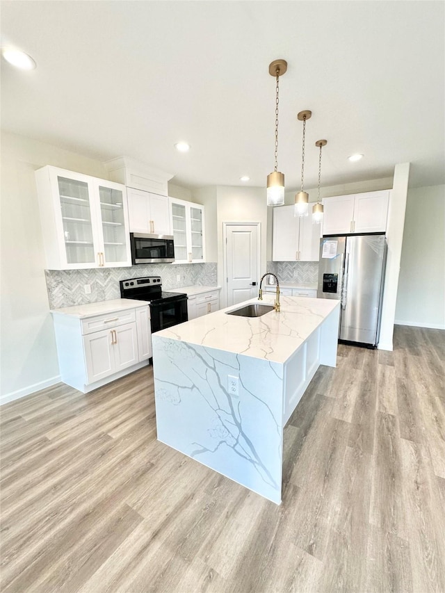 303 Third, Lindsay, TX 76250 - kitchen with decorative backsplash, a sink, light wood-style floors, stainless steel appliances, and white cabinetry