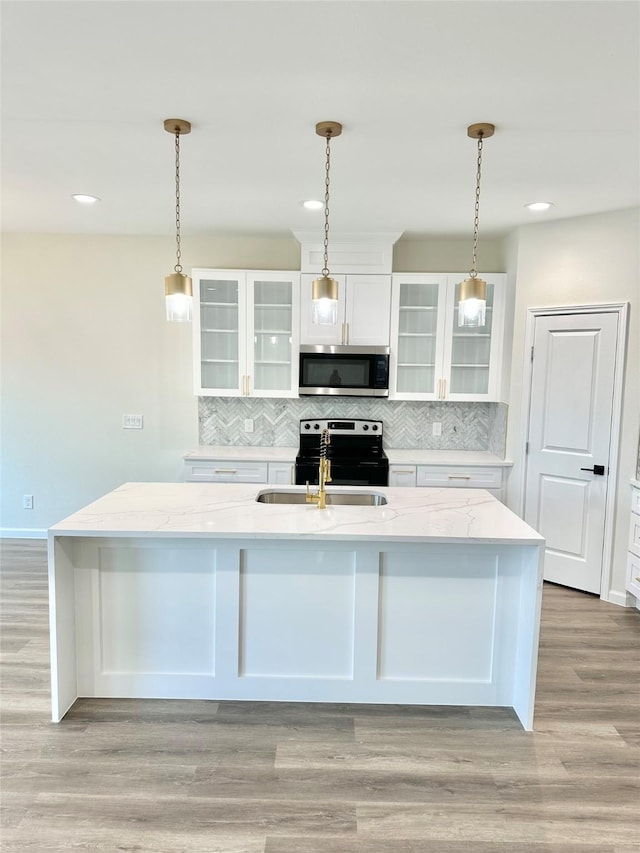 303 Third, Lindsay, TX 76250 - kitchen with tasteful backsplash, a sink, stainless steel microwave, electric stove, and white cabinetry