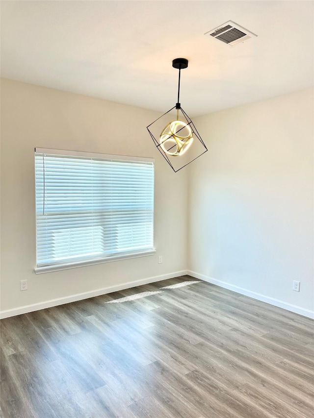 303 Third, Lindsay, TX 76250 - spare room featuring baseboards, visible vents, and wood finished floors