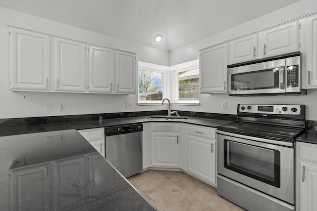 kitchen with a sink, light tile patterned floors, white cabinets, and stainless steel appliances