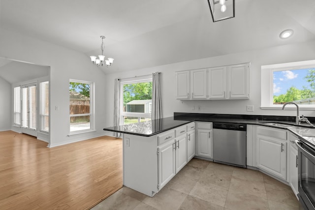 kitchen with stainless steel dishwasher, a sink, a peninsula, lofted ceiling, and white cabinetry