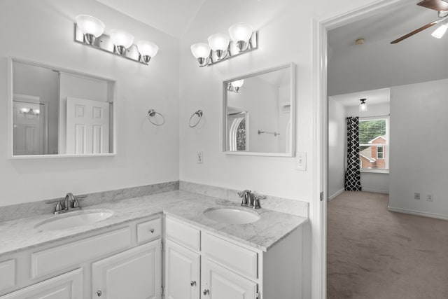 bathroom featuring double vanity, a sink, ceiling fan, and lofted ceiling
