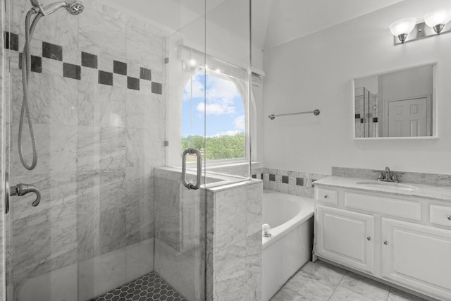 bathroom featuring vanity, a garden tub, marble finish floor, and a stall shower