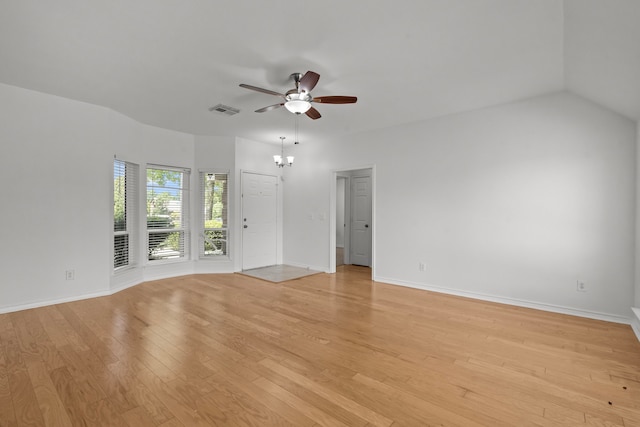 empty room featuring baseboards, visible vents, light wood finished floors, and ceiling fan with notable chandelier