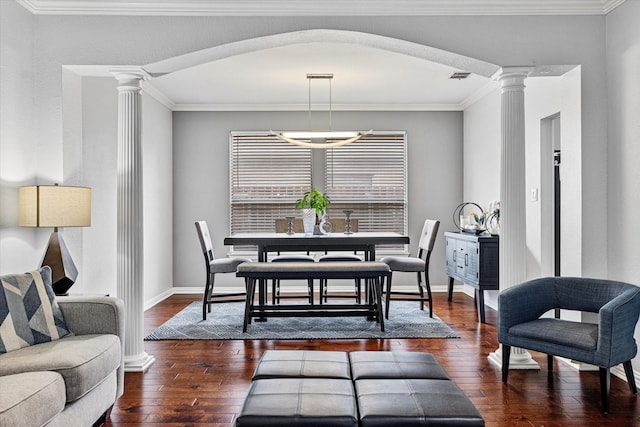 dining space with ornate columns, baseboards, visible vents, and hardwood / wood-style flooring