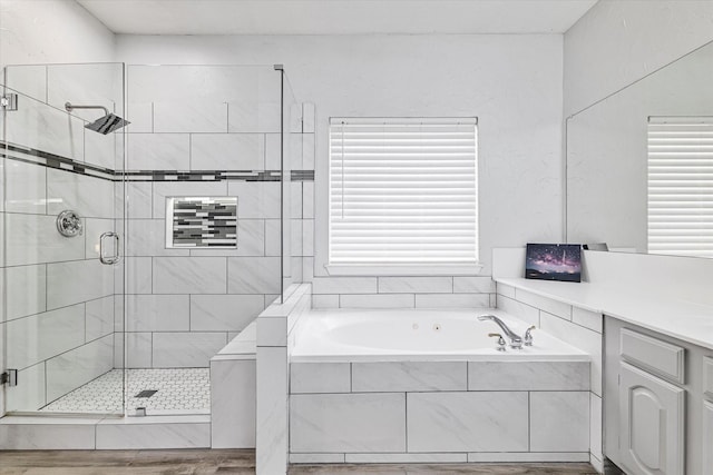 full bath featuring a garden tub and a stall shower