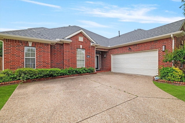 ranch-style home featuring a garage, a shingled roof, driveway, and brick siding
