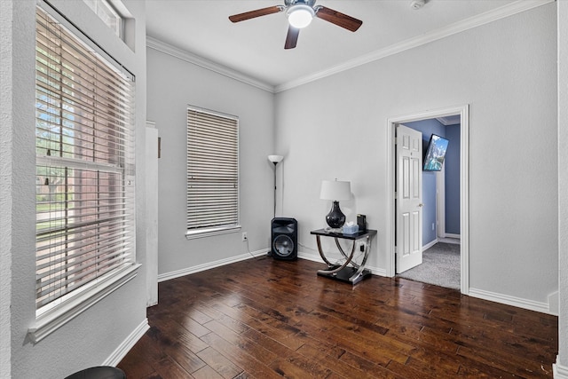unfurnished room featuring crown molding, baseboards, wood-type flooring, and a ceiling fan